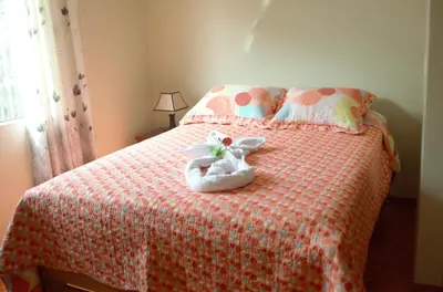 a bedroom with a bed with a pair of shoes on it at Rosenverg B&B Tours in Lima