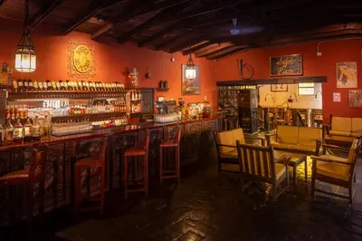 a bar with chairs and a counter in a room at Decameron El Pueblo in Lima
