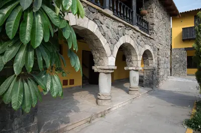 a building with arches on the side of it at Decameron El Pueblo in Lima