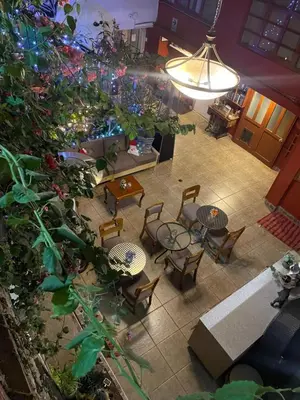 an overhead view of a patio with tables and chairs at Blacky Hostel and Apartments in Cusco