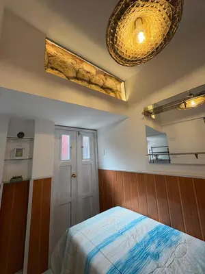 a bedroom with a bed and a ceiling at Blacky Hostel and Apartments in Cusco