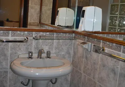 a bathroom with a sink and a mirror at Nodo Cusco Garcilaso in Cusco