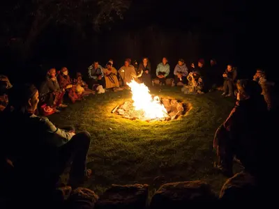 a group of people sitting around a fire at Willka T'ika in Urubamba