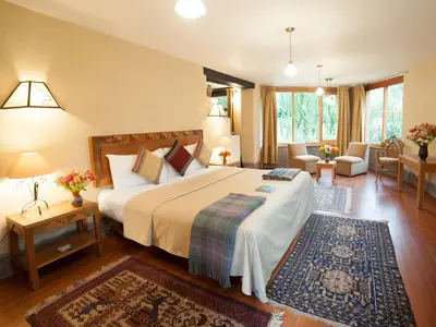 a bedroom with a large bed and a living room at Willka T'ika in Urubamba