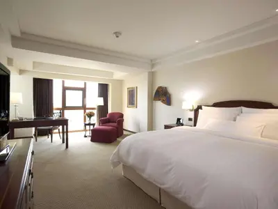 a hotel room with a large bed and a desk at Swissotel Lima in Lima