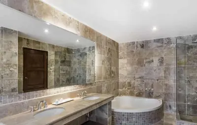 a bathroom with two sinks and a tub at Wyndham Costa del Sol Cusco in Cusco