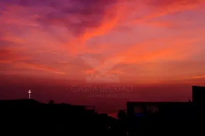 a cross in the sky at sunset at Casita Libertad Chorrillos in Lima