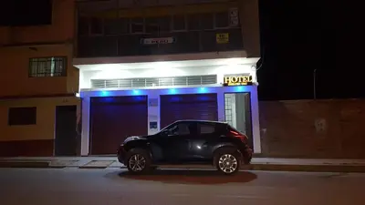 a black car parked in front of a hotel at Hotel Shelter in Huancayo