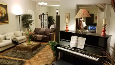 a living room with a piano and a couch at Casa Bella Boutique Hotel San Isidro in Lima