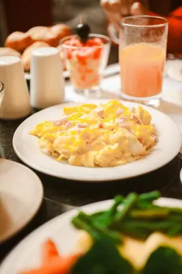 a table with a plate of food on a table at Los Tallanes Hotel & Suites in Lima