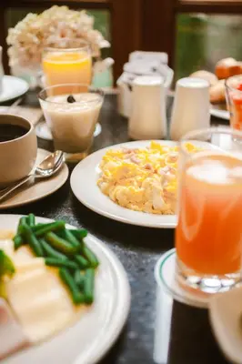 a table with plates of food and drinks on it at Los Tallanes Hotel & Suites in Lima