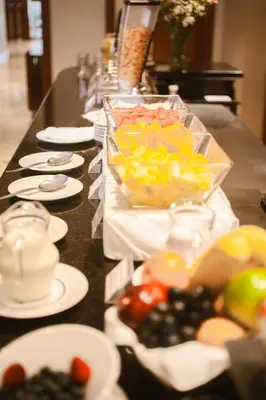 a buffet with plates of food on a table at Los Tallanes Hotel & Suites in Lima