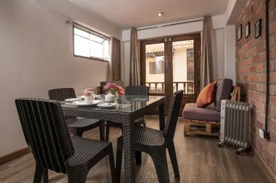 a dining room with a table and chairs at Casa Cavassa Centro Histórico Cusco in Cusco