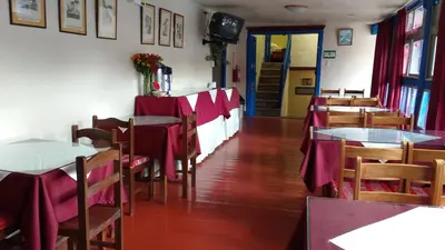 a dining room with tables and chairs with red table cloth at Casa Grande Colonial Palace in Cusco