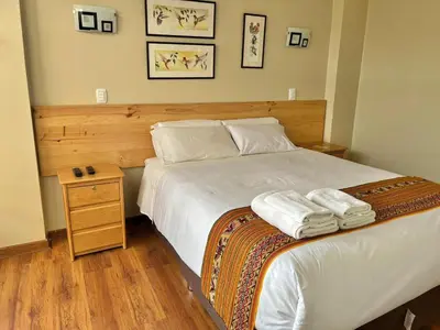 a bedroom with a bed with two towels on it at Hostal Casona Arrambide in Cusco