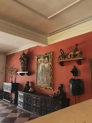 a room with red walls and a painting on the wall at Hotel San Isidro Inn in Lima