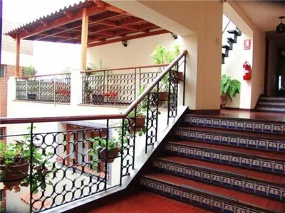 a set of stairs in a building with potted plants at Hotel San Isidro Inn in Lima