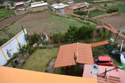 an aerial view of a house with a yard at La Finca Tarma in Tarma