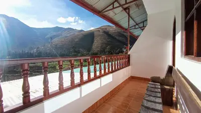 a balcony with a view of a mountain at La Finca Tarma in Tarma