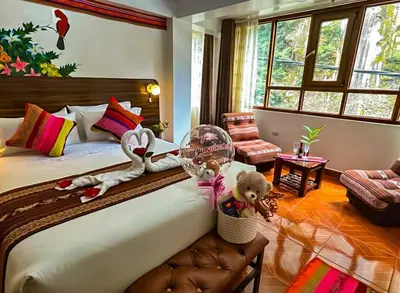 a bedroom with a bed with stuffed animals on it at Hotel Machupicchu Adventure in Machu Picchu