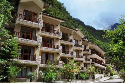 a building with balconies on the side of a mountain at Sumaq Machu Picchu Hotel in Machu Picchu
