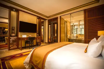 a bedroom with a bed and a desk and a television at Sumaq Machu Picchu Hotel in Machu Picchu