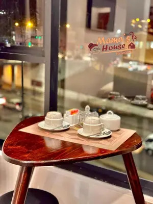 a table with cups and saucers on top at Mama's House in Cusco
