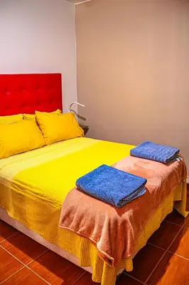 a bed with two towels on top of it at Del Valle House in Ica