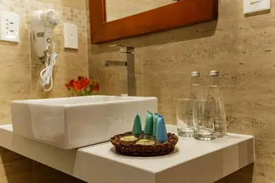 a bathroom with a sink and a basket of toiletries at Yawar Inka Hotel in Cusco