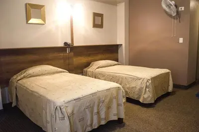 a hotel room with two beds in a room at Kamana Hotel in Lima