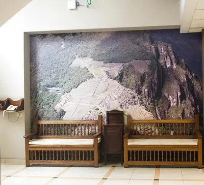two benches in a room with a mural on the wall at Kamana Hotel in Lima
