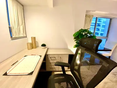 an office with a desk and a chair in a room at Moon Luxury Apartments in Lima