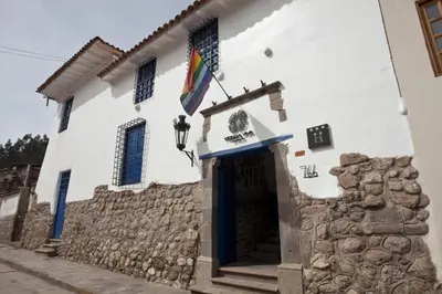a white building with a flag on it at Tierra Viva Cusco Saphi Hotel in Cusco