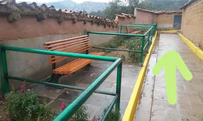 a wooden bench sitting on the side of a building at Wichana Wasi in Cusco