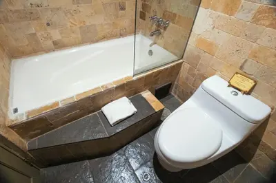 a bathroom with a toilet and a bath tub at Tambo del Arriero Hotel Boutique in Cusco