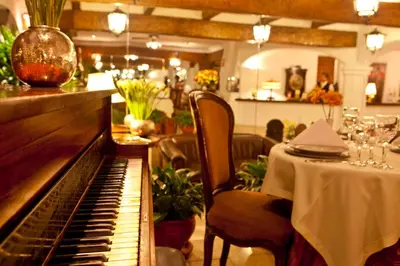 a piano sitting in a restaurant with a table with a tablestration at Antara Hotel & Suites - Miraflores in Lima