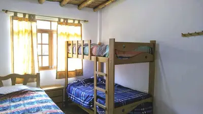 a bedroom with two bunk beds in a room at Casa de Campo Belén - Lunahuaná in Lunahuaná