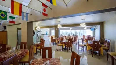 a restaurant with tables and chairs and flags on the ceiling at Suites Larco 656 Miraflores Lima in Lima