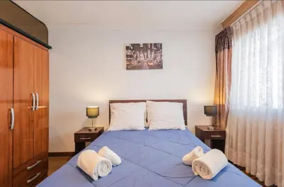 a bedroom with a blue bed with towels on it at Apartamento en el centro Cusco Inlove in Cusco