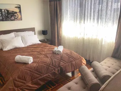 a bedroom with a bed with two towels on it at Excelente ubicación en el Centro Cusco Inlove in Cusco