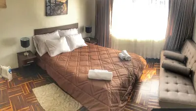 a bedroom with a large bed with two towels on it at Excelente ubicación en el Centro Cusco Inlove in Cusco