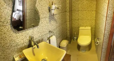 a bathroom with a sink and a toilet and a mirror at Excelente ubicación en el Centro Cusco Inlove in Cusco