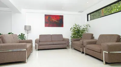 a waiting room with two chairs and a couch at Golden Sunrise Machupicchu in Machu Picchu