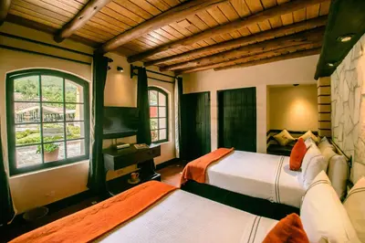 a bedroom with two beds and a window at Sonesta Posadas del Inca - Valle Sagrado Yucay Urubamba in Urubamba