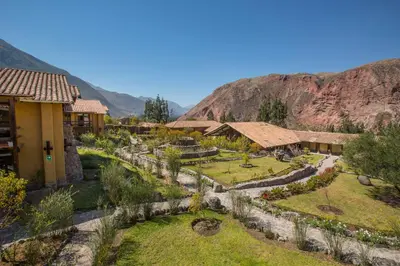 a resort with a garden and mountains in the background at Tierra Viva Valle Sagrado Hotel in Urubamba