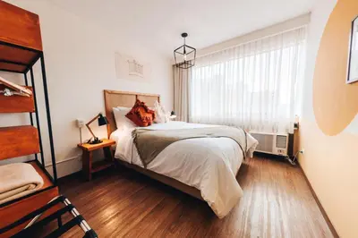 a bedroom with a bed and a window at qema Lima in Lima