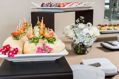 a table with a plate of food on a table at Sonesta Hotel El Olivar in Lima
