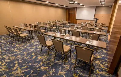 a room with tables and chairs in a classroom at Sonesta Hotel El Olivar in Lima