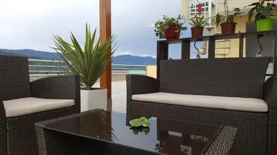 a patio with wicker chairs and a table at Terraza Apart Hotel in Pichanaki
