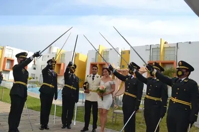 a bride and groom in military uniforms with their soldiers at Kajaca Suite Hotel in Huacho